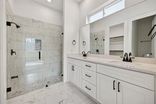 a bathroom with a shower sink and mirror