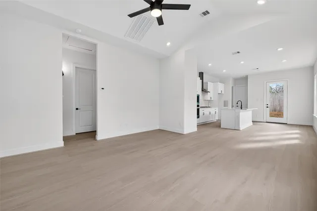 a view of an empty room with a kitchen
