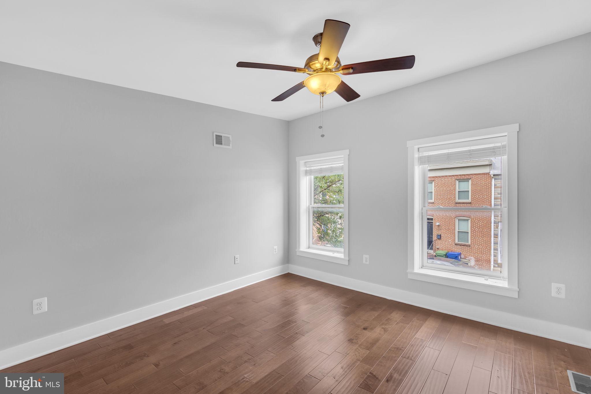 1827 Light Street Baltimore, MD 21230 - Photo 11 of 28 a view of an empty room with wooden floor and a window