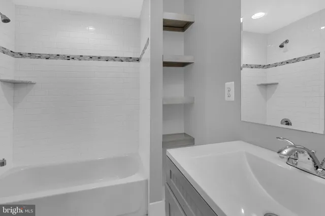 a bathroom with a bathtub and a sink