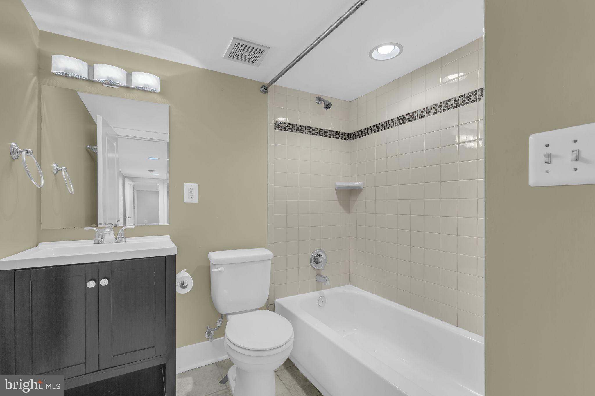 1827 Light Street Baltimore, MD 21230 - Photo 24 of 28 a bathroom with a sink a toilet and shower