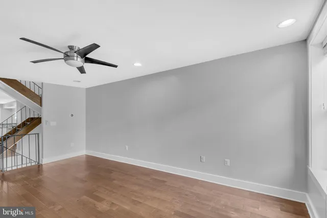 a view of a ceiling fan and wooden floor