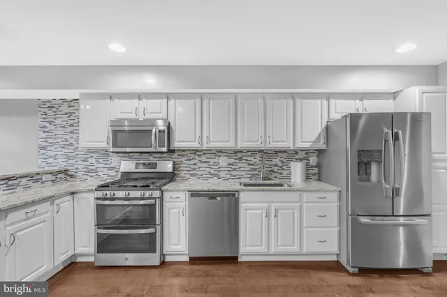 a kitchen with stainless steel appliances a refrigerator stove and microwave