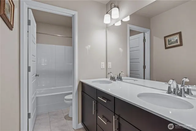 a bathroom with a granite countertop sink a toilet and a mirror