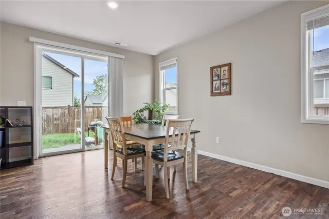 a view of a dining room with furniture window and wooden floor