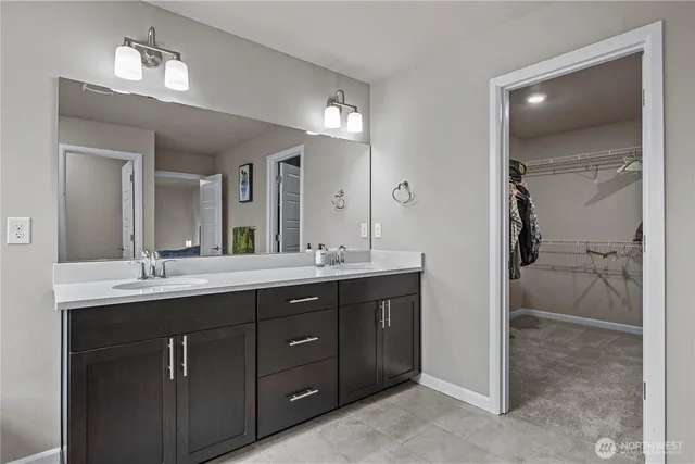 a bathroom with a double vanity sink and a mirror