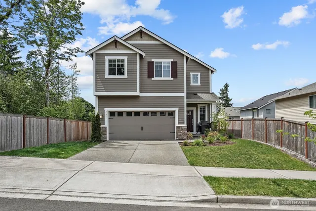 a front view of a house with a garden and plants