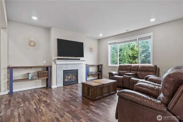 a living room with furniture a fireplace and a flat screen tv