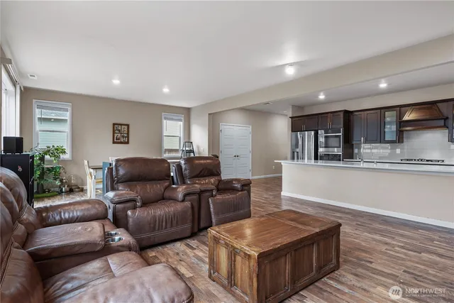 a living room with furniture and kitchen view