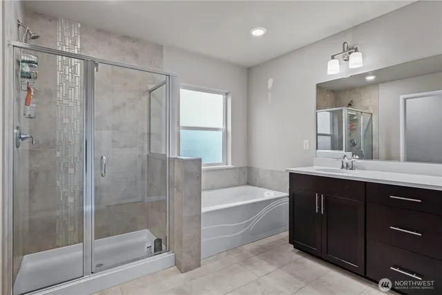 a bathroom with a tub a sink and mirrors