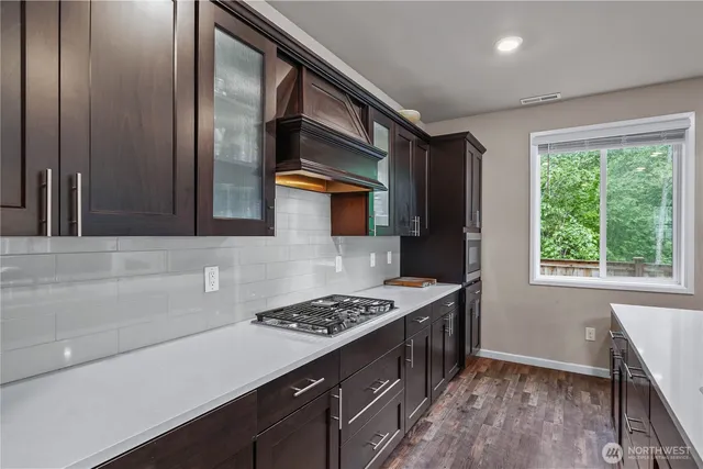 a kitchen with stainless steel appliances a stove a sink and a refrigerator