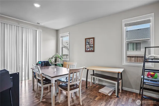 a view of a dining room with furniture and wooden floor