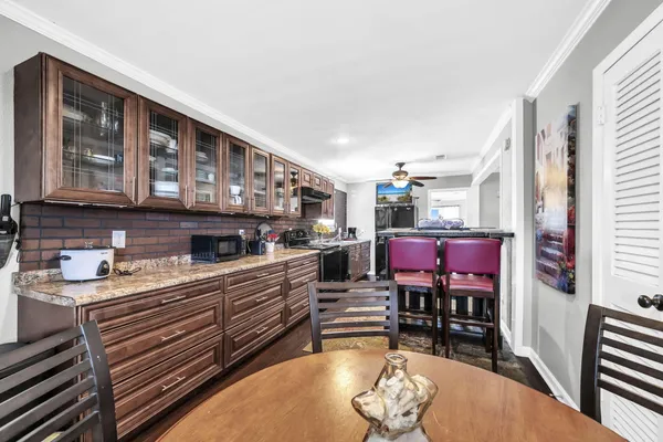 a open kitchen with stainless steel appliances granite countertop a stove a sink dishwasher and cabinets with wooden floor