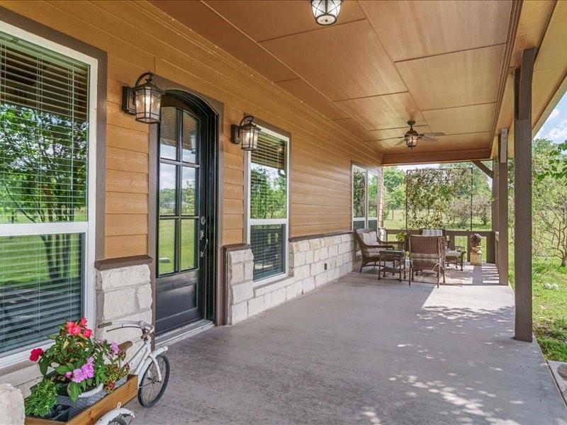 6969 Highway 198 Canton, TX 75103 - Photo 11 of 40 a view of a porch with chairs and potted plants