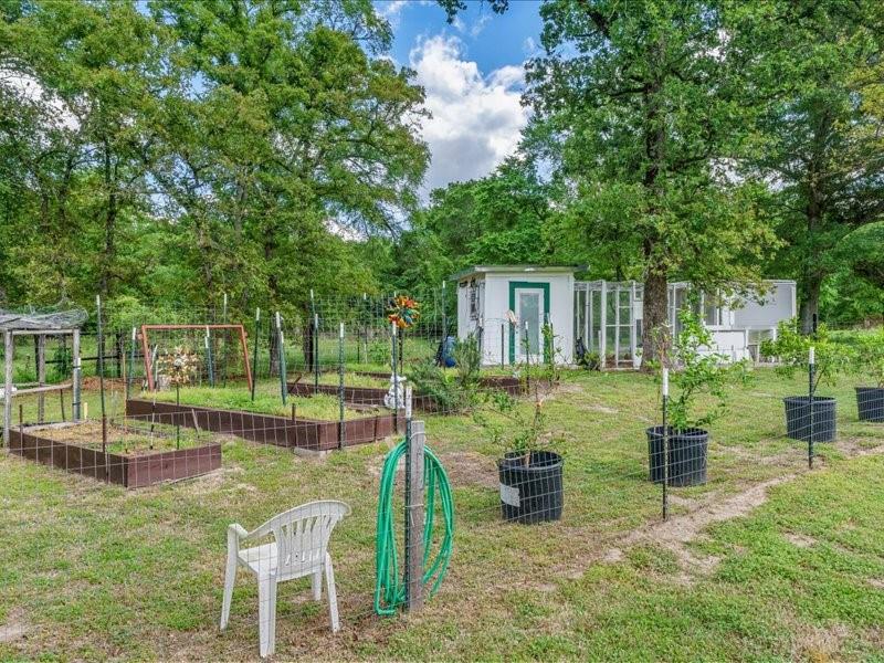 6969 Highway 198 Canton, TX 75103 - Photo 15 of 40 a view of a house with backyard sitting area and garden
