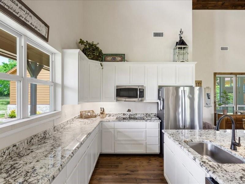 6969 Highway 198 Canton, TX 75103 - Photo 26 of 40 a kitchen with stainless steel appliances granite countertop a sink stove and refrigerator