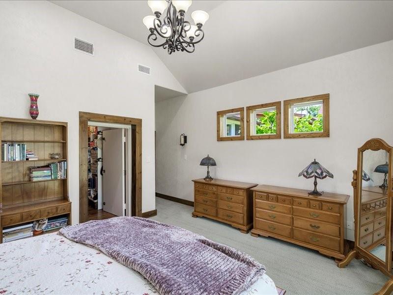 6969 Highway 198 Canton, TX 75103 - Photo 28 of 40 a spacious bedroom with a bed and a chandelier