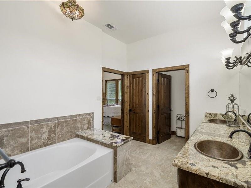 6969 Highway 198 Canton, TX 75103 - Photo 29 of 40 a bathroom with a granite countertop sink and a bathtub