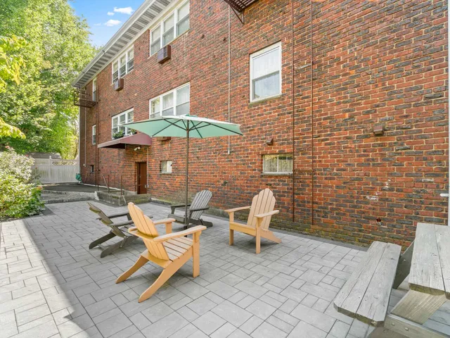 a view of a patio with a table and chairs