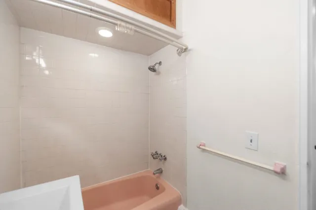 a bathroom with a tub and shower