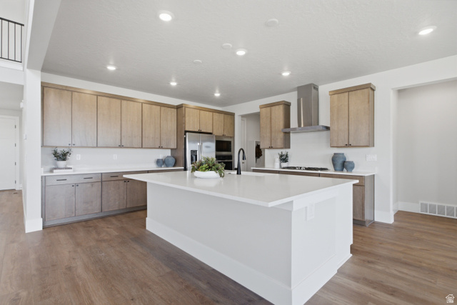 978 South Romney Road, Unit 240 Heber City, UT 84032 - Photo 2 of 9 Kitchen featuring wood-finish cabinetry, stainless steel appliances, a center island with a white countertop and recessed lighting