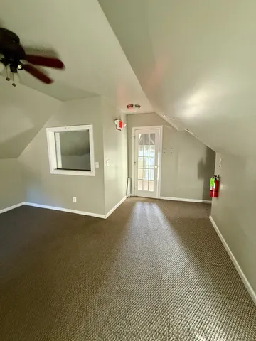a view of an empty room and a window