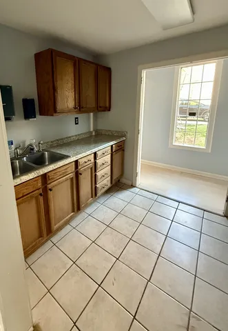 a kitchen with a stove a sink and a refrigerator