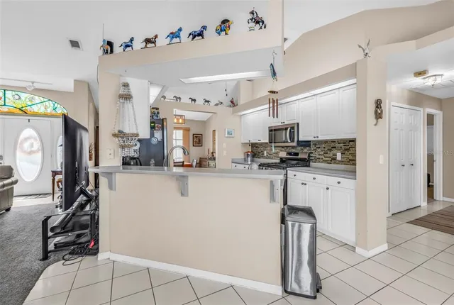 a kitchen with granite countertop a sink window and cabinets