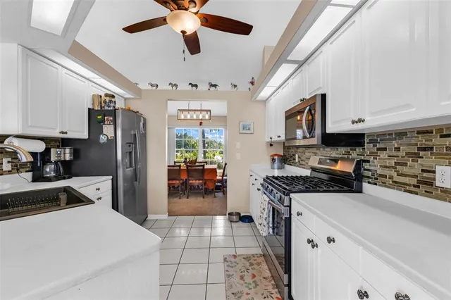 a kitchen with stainless steel appliances granite countertop a stove cabinets and a refrigerator