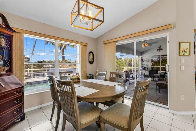 a room with stainless steel appliances kitchen island granite countertop furniture and a flat screen tv