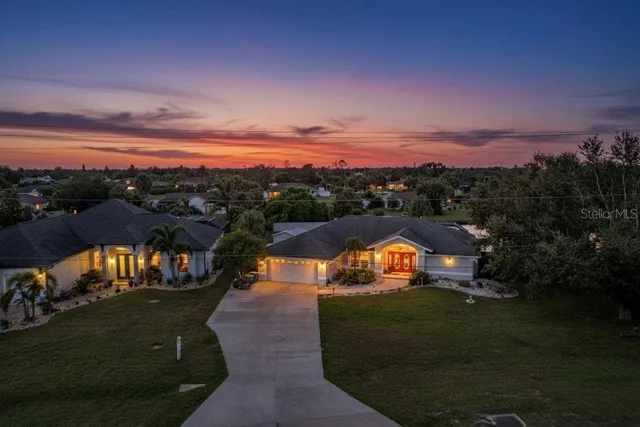 a view of a swimming pool with an outdoor seating and a garage