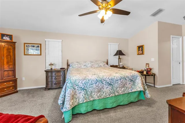 a kitchen with kitchen island white cabinets and refrigerator