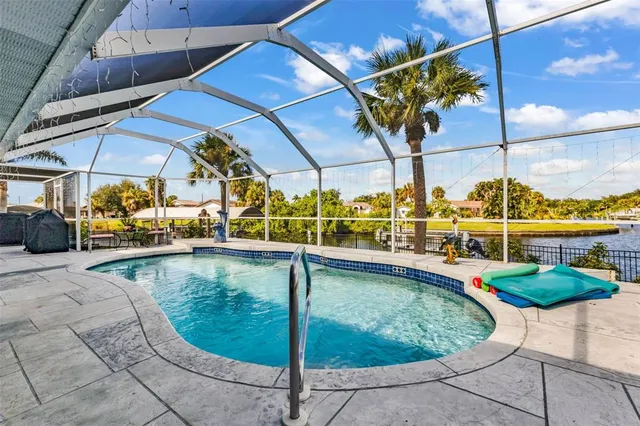 a view of a backyard with swimming pool