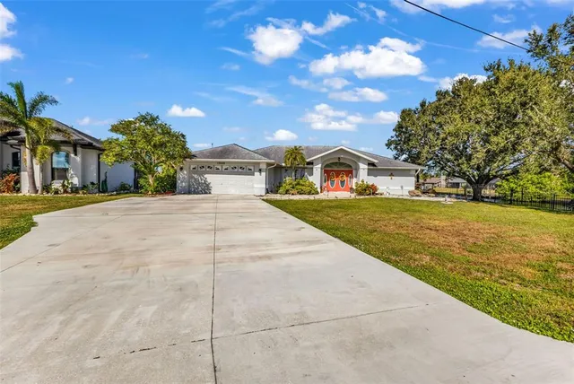 a front view of house with yard and swimming pool