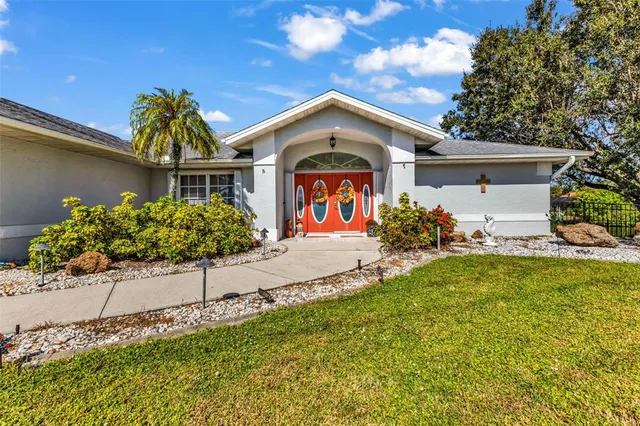 a living room with furniture ceiling fan and a large window