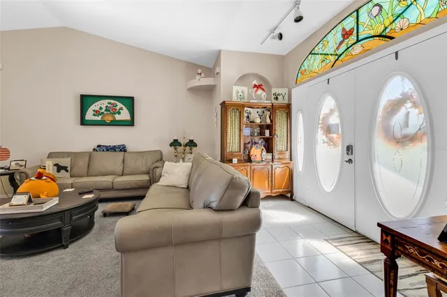 a living room with furniture and a chandelier