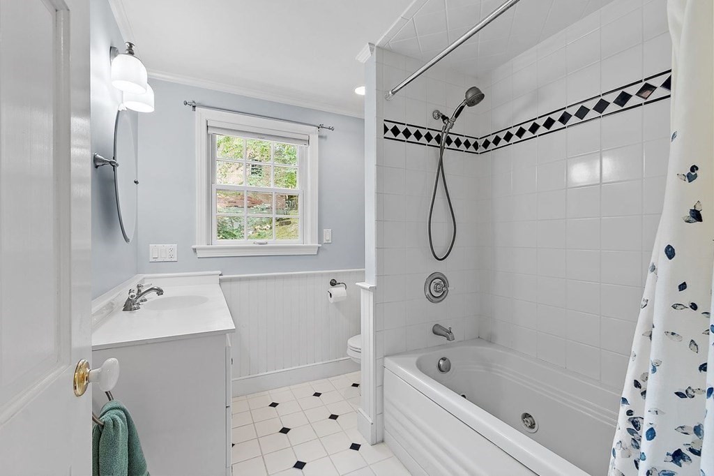 52 Edgewood Road Concord, MA 01742 - Photo 17 of 29 a bathroom with a bath tub a sink and a window