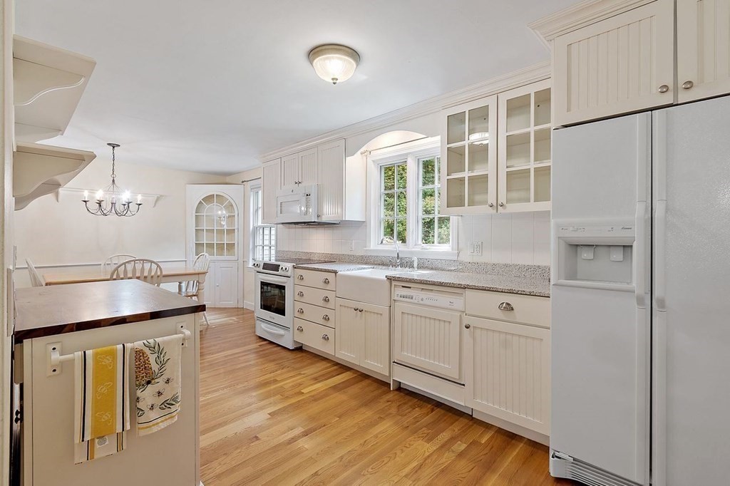 52 Edgewood Road Concord, MA 01742 - Photo 7 of 29 a kitchen with granite countertop white cabinets and white appliances