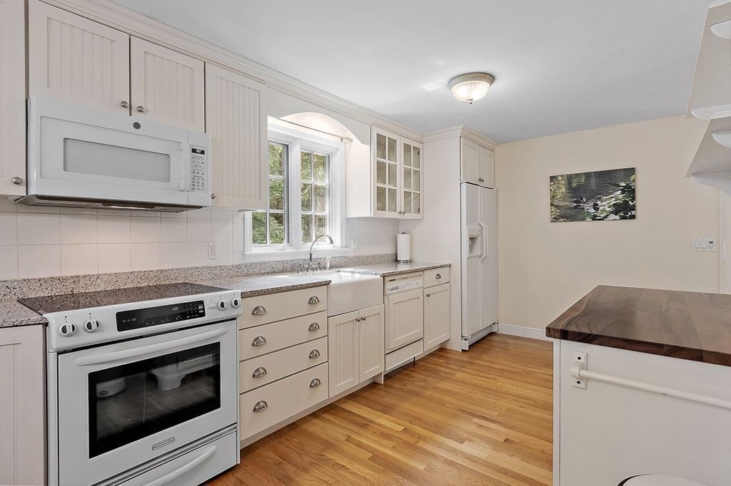 52 Edgewood Road Concord, MA 01742 - Photo 10 of 29 a kitchen with stainless steel appliances granite countertop a stove a sink and a microwave