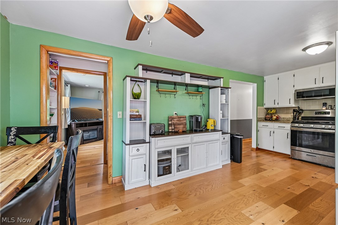 15111 Mt Eaton Road North Rittman, OH 44270 - Photo 12 of 50 Kitchen with breakfast bar, white cabinetry and wood flooring