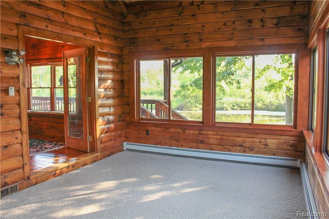 4165 Morgan Road Lake Orion, MI 48359 - Photo 46 of 81 Lovely Sun Room filled with natural light and a view of both the front of the home and the pond in the back.