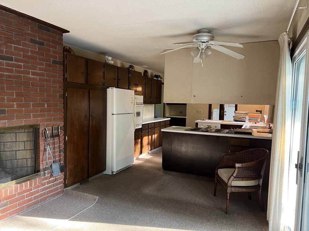 325 Marion Road Wareham, MA 02571 - Photo 12 of 29 a kitchen with a refrigerator and a sink
