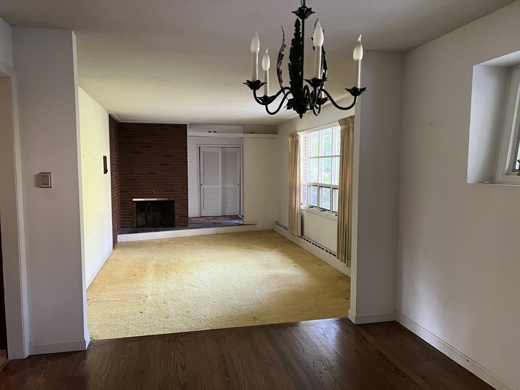 325 Marion Road Wareham, MA 02571 - Photo 24 of 29 a view of empty room with wooden floor and chandelier
