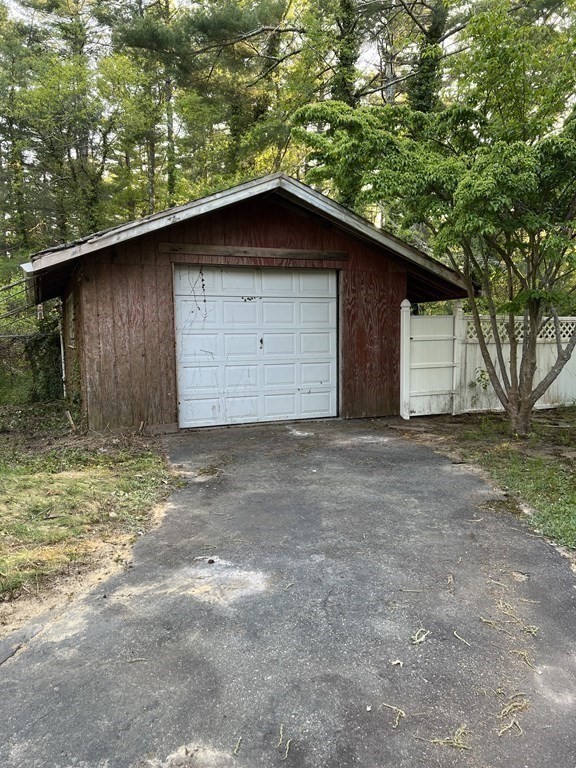 325 Marion Road Wareham, MA 02571 - Photo 25 of 29 a wooden door in front of a house with large tree
