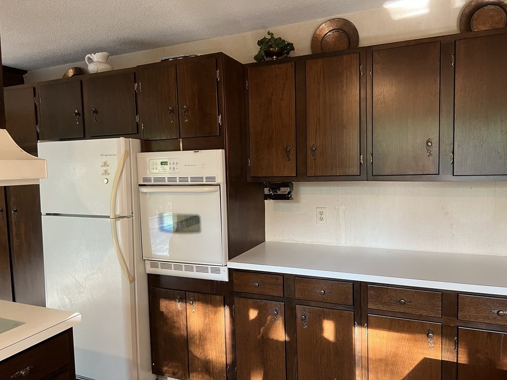 325 Marion Road Wareham, MA 02571 - Photo 10 of 29 a white refrigerator freezer sitting inside of a kitchen