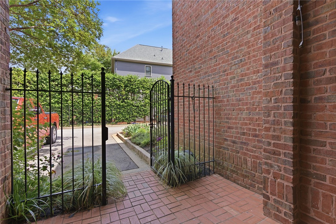 204 Butler Avenue Greenville, SC 29601 - Photo 25 of 26 A private gated entry leads to a paved pathway and a vibrant garden space.