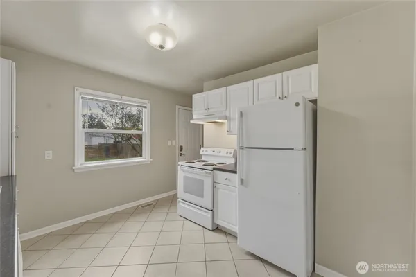 a kitchen with stainless steel appliances a refrigerator sink and microwave