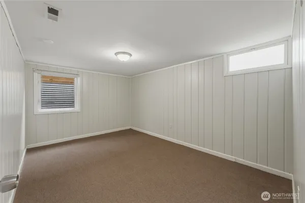 an empty room with a empty space and windows