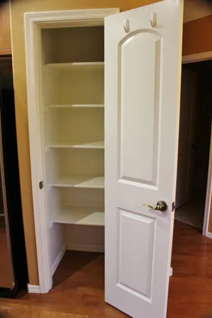 a view of walk in closet with empty racks
