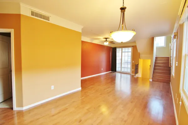 a view of a room with wooden floor and a window